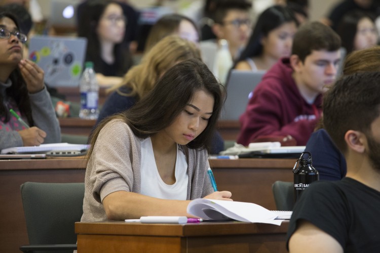 Image of Thao Atkinson taking notes in class