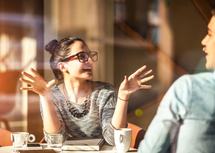 Image of a woman and man talking at a table