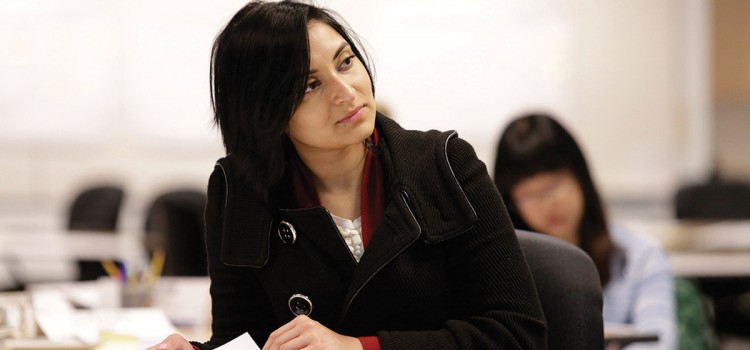 woman sitting at a table look off to the right