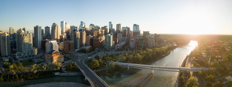 Aerial panoramic view of a beautiful modern cityscape during a vibrant sunny sunrise. Taken in Calgary Downtown, Alberta, Canada.