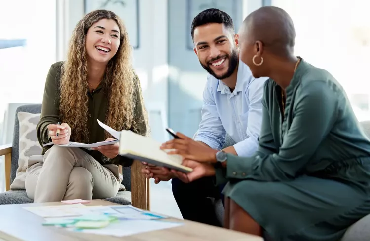 Happy business people smile during a planning meeting in a startup marketing agency office. Diversity, collaboration and teamwork in a healthy work environment in an international advertising