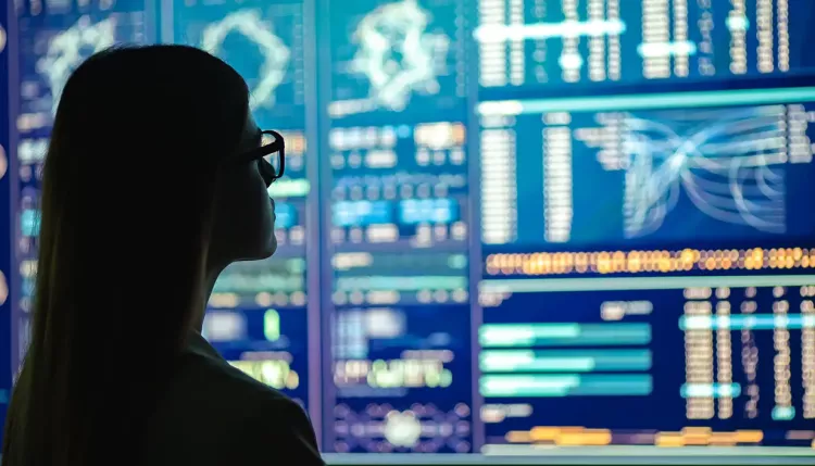 The businesswoman in glasses standing near the display